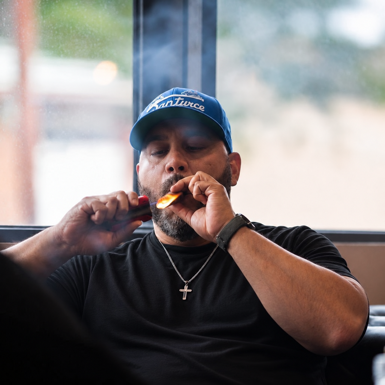 Juan Fernandez Jr., Founder & CEO of The DrawIQ smoking a cigar